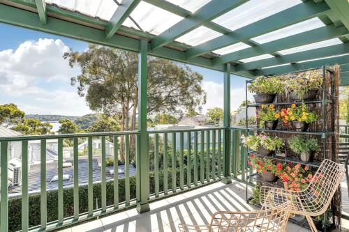 pérgola en un balcón con flores y plantas en Harbourside Pad with Waterfront Views en Sídney