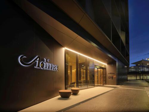 a building with a sign on the side of it at Adina Apartment Hotel Vienna Belvedere in Vienna