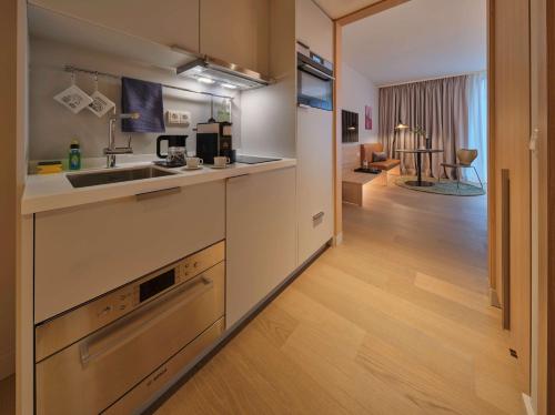 a kitchen with a sink and a counter at Adina Apartment Hotel Vienna Belvedere in Vienna