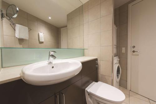 a bathroom with a sink and a toilet at Adina Apartment Hotel Copenhagen in Copenhagen