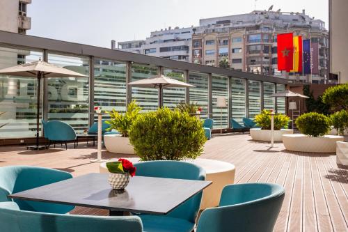 a table and chairs on a rooftop patio at Barceló Anfa Casablanca in Casablanca