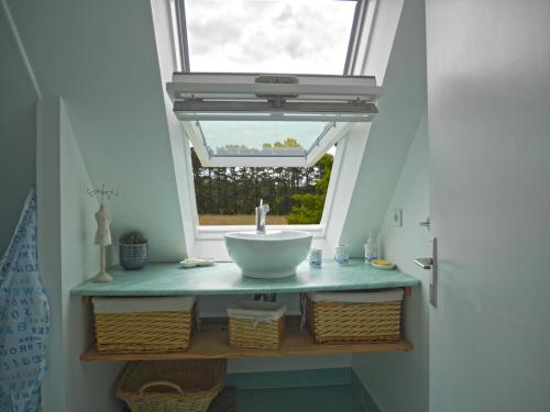a bathroom with a sink under a window at Maison de qualité avec jardin paysager à Sauzon - FR-1-418-38 in Sauzon