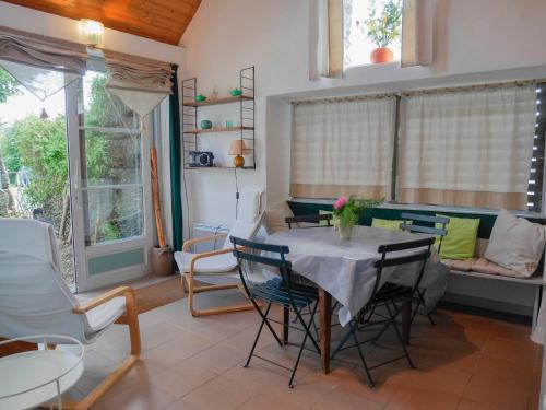 une salle à manger avec une table et des chaises dans l'établissement Maison 2 ch. à Locmaria, 800m de la plage, jardin clos, animaux OK, équipements complets - FR-1-418-158, à Locmaria