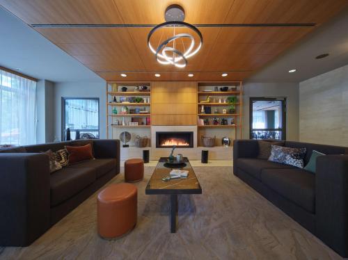 a living room with two couches and a fireplace at Adina Apartment Hotel Berlin Mitte in Berlin
