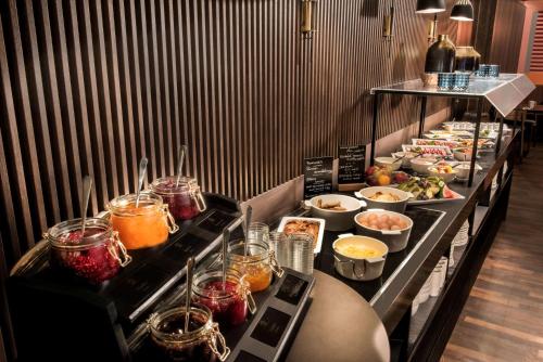a buffet line with many different types of food at Adina Apartment Hotel Leipzig in Leipzig