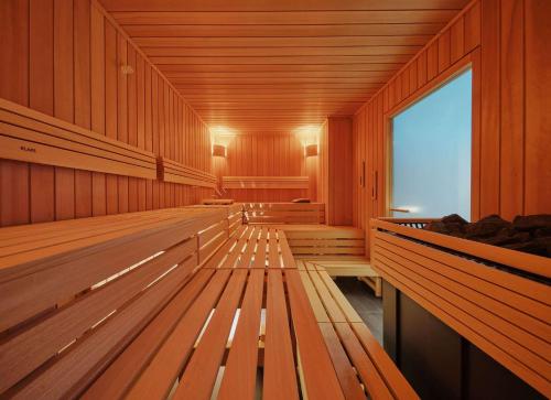 a row of wooden benches in a gymnasium at Adina Apartment Hotel Cologne in Cologne