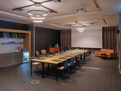 a conference room with a long table and chairs at Adina Apartment Hotel Cologne in Cologne