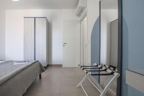a bedroom with a bed and a mirror at Skyfive Water Apartment in Alghero