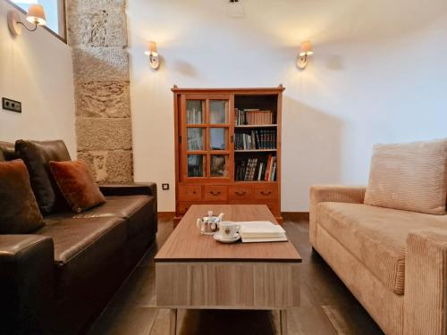 a living room with a couch and a coffee table at Hotel Rural Candela y Plata in Puerto de Béjar