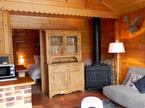 a living room with a stove in a log cabin at Le Petit Skieur B&B in Le Sappey-en-Chartreuse