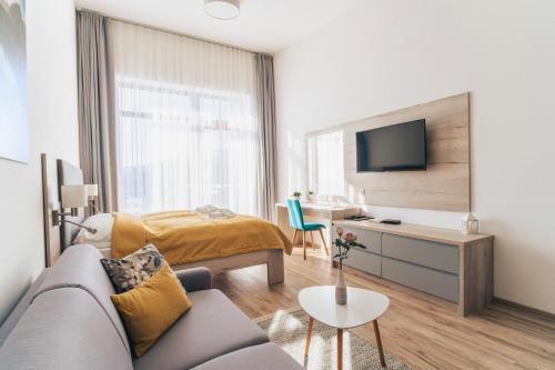 a living room with a couch and a bed at Apartmány Tatry in Smokovce