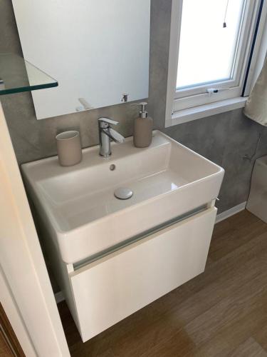 a white sink in a bathroom with a mirror at Agricamping Zanina 9 in Peschiera del Garda