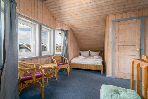 a small room with a bed and a table and chairs at Ferienhaus Am Durland in Zielow