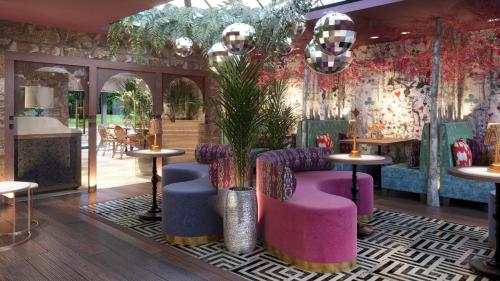 a restaurant with purple chairs and tables and plants at The Tempus at Charlton Hall Estate in Alnwick