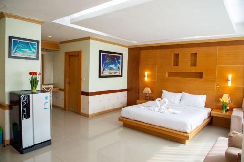 a bedroom with a large white bed and a couch at Patong eyes in Patong Beach