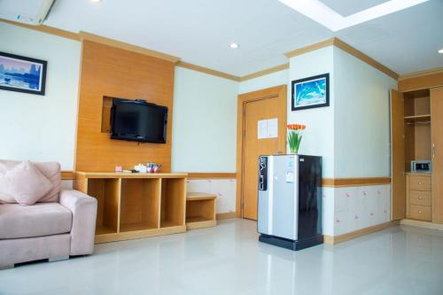 a living room with a refrigerator and a couch at Patong eyes in Patong Beach