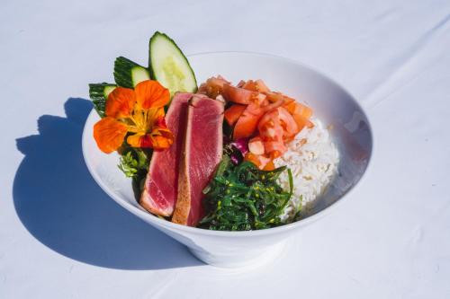 a bowl of food with rice and fruits and vegetables at Coco Reef Bermuda in Mount Pleasant