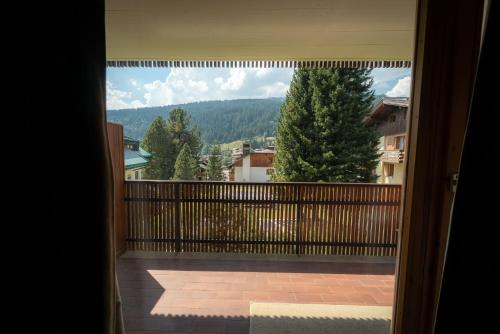 a view of a balcony with a view of the mountains at Mandron charming and central apartment in Madonna di Campiglio