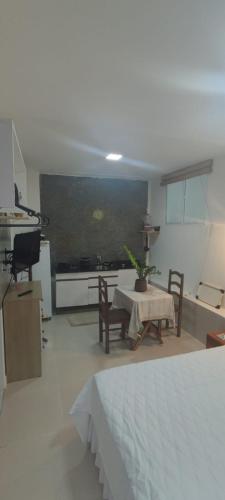 a living room with a table and chairs and a tv at Residencial Temporada Aracaju in Aracaju