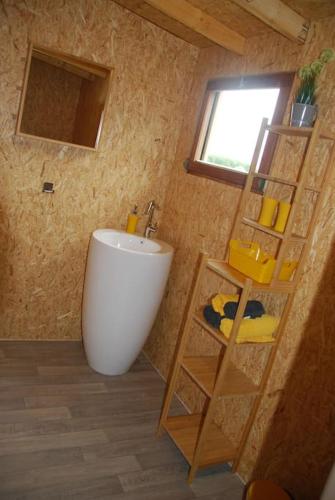 a bathroom with a white tub and a sink at Anima'Sphair Bulle près des animaux in Bras-Haut
