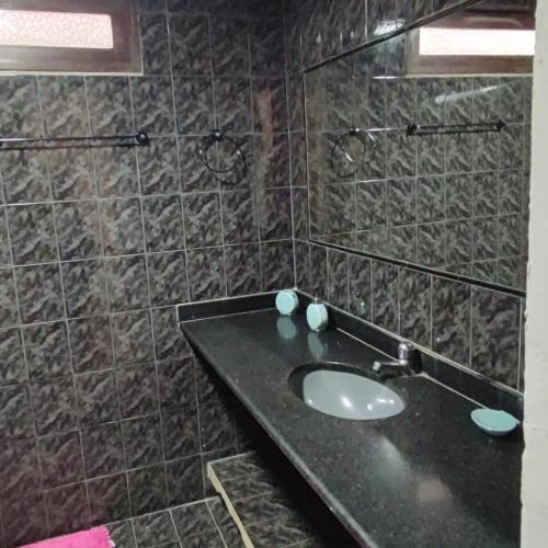 a bathroom with a sink and a mirror at Residencial Temporada Aracaju in Aracaju