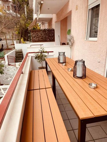 two wooden benches sitting on top of a patio at Aquamarine Maisonette in Siviri