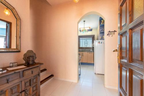 a kitchen with an archway and a refrigerator at Villa Bonaventura in Calonge