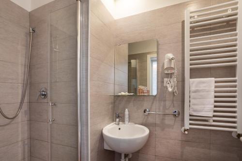 a bathroom with a sink and a shower at Hb Hotels Orchidea Blu in Rimini