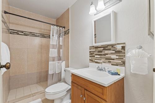 a bathroom with a sink and a toilet and a shower at Kihei Bay Surf B212 in Kihei