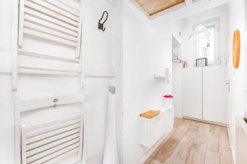 a white hallway with white walls and wood floors at Tamka 45A by Homeprime in Warsaw