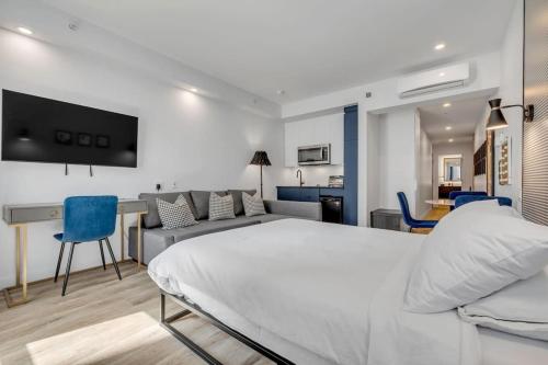 魁北克市的住宿－Initial / Icone / Quebec+stat，卧室配有一张白色的大床和一张沙发。