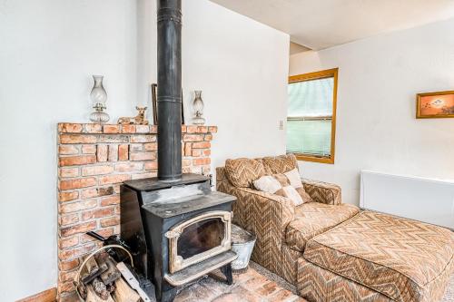 a living room with a brick fireplace next to a couch at Pandora in Shaver Lake