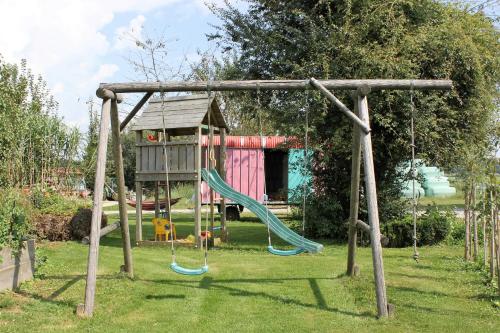 a swing set in a yard with a playground at Ferienhaus Eller in Traunwalchen