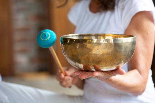 a woman holding a mixing bowl and a wooden spoon at Hotel Land Gut Höhne in Mettmann