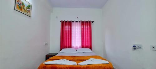 a bedroom with a bed with a red window at The Coorg Heaven in Madikeri
