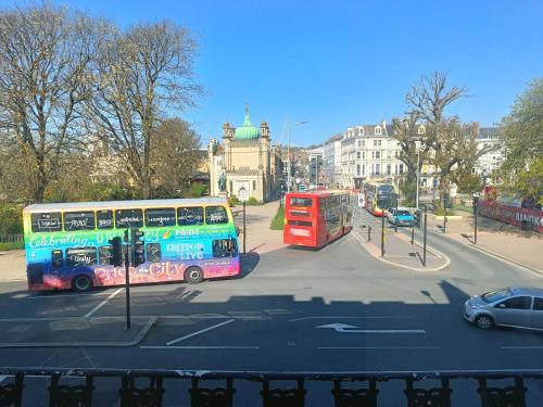 a double decker bus and a red double decker bus at Kipps Brighton in Brighton & Hove