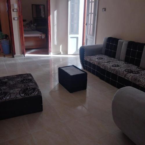 a living room with a couch and a stool at Addas Home in Siwa