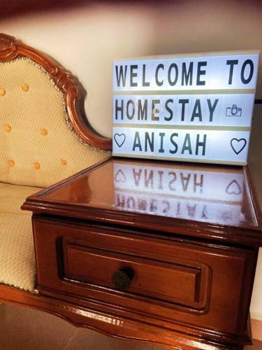 a stack of books sitting on top of a dresser at Batu Pahat Hill View Homestay in Batu Pahat