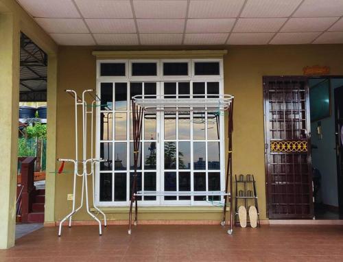 a front door of a house with a window at Batu Pahat Hill View Homestay in Batu Pahat