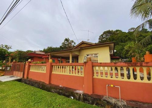 a house with a fence in front of it at Batu Pahat Qastina Gunong Soga Homestay in Batu Pahat