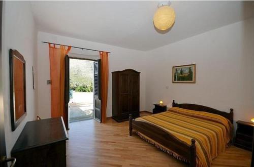 a bedroom with a bed and a sliding glass door at B&B Raggio Verde in Castelluzzo