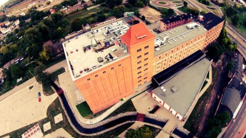 an overhead view of a large building with a red roof at Hotel Młyn Toruń - dawne MCSM in Toruń