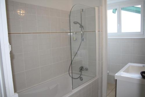 a shower with a glass door in a bathroom at Hôtel de la Rhune in Ascain