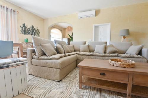 a living room with a couch and a coffee table at Ogygia Suites Gozo in Għarb