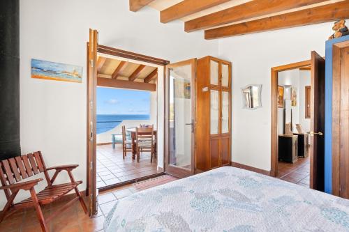 a bedroom with a view of the ocean at Binizzy in Cala Morell