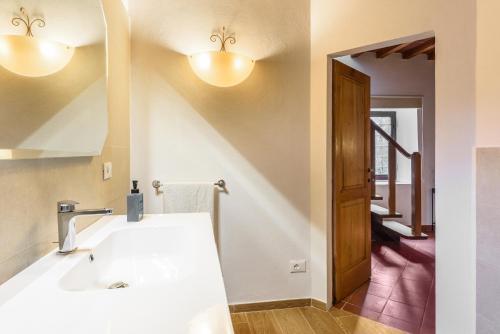 a bathroom with a sink and a mirror at Tenuta Poggio ai Mandorli in Greve in Chianti