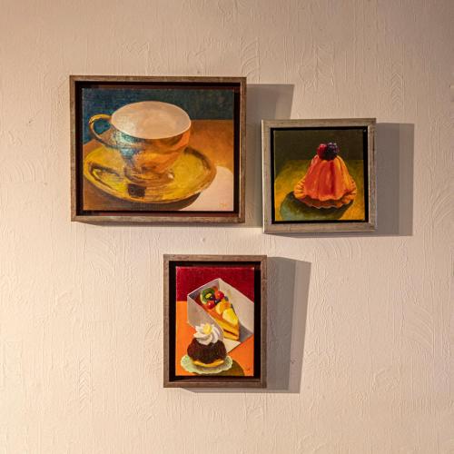 three pictures of food and a cup on a wall at Berghotel Waidmannsheil in Battenberg