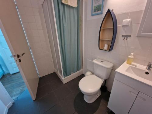 a bathroom with a toilet and a sink and a shower at The Aqueduct Guesthouse in Évora