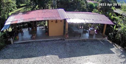a house with a porch with a roof at Hospedaje Poly in Río Claro