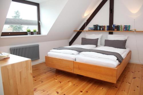 a bedroom with a wooden bed in a room at Ferienwohnung Utkiek an der Müritz in Rechlin